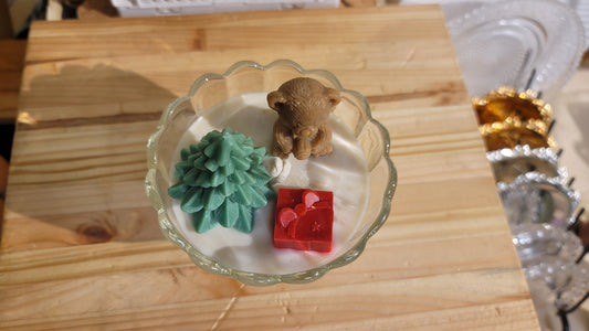 Gift bear candle close-up showing detailed bow and charming holiday character appearance