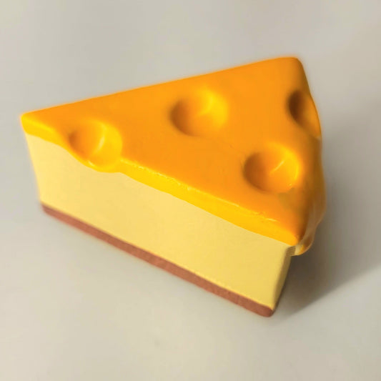 Cheesecake magnet close-up showing detailed creamy texture and authentic slice presentation