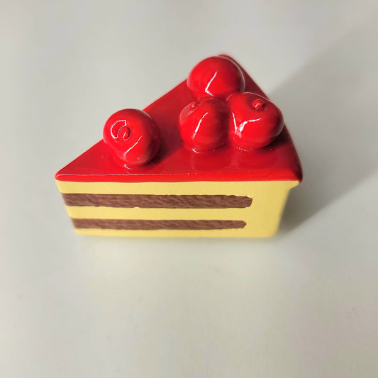 Cherry cake magnet close-up showing detailed layers, frosting and cherry garnish