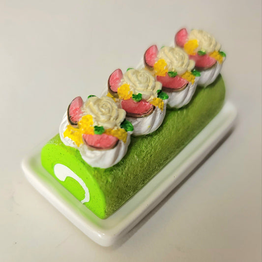 Cake roll magnet close-up showing detailed spiral layers and creamy filling texture