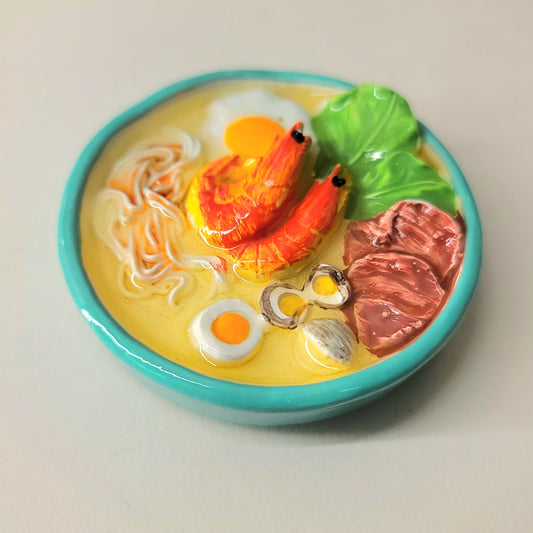 Seafood noodle magnet close-up showing detailed noodles, seafood and appetizing presentation