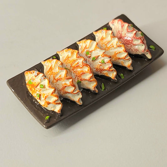 Potsticker magnet close-up showing detailed gyoza dumplings and appetizing presentation