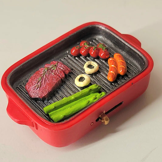 BBQ red skillet magnet close-up showing detailed grilled meat and vegetables in pan