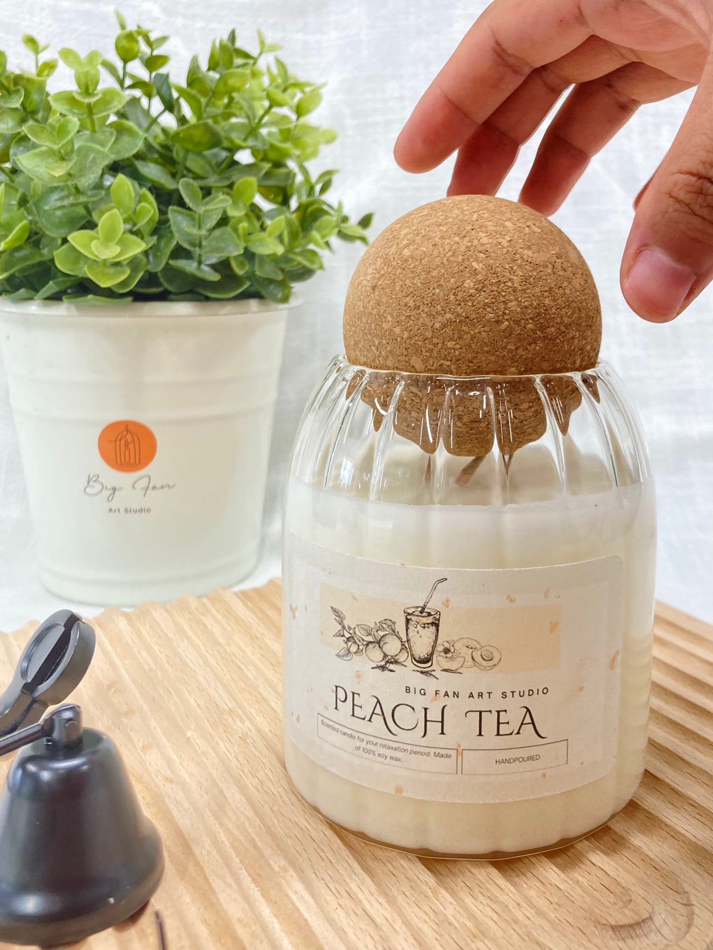 Big Fan Art Studio label detail on the striped glass jar of the Signature Candle.