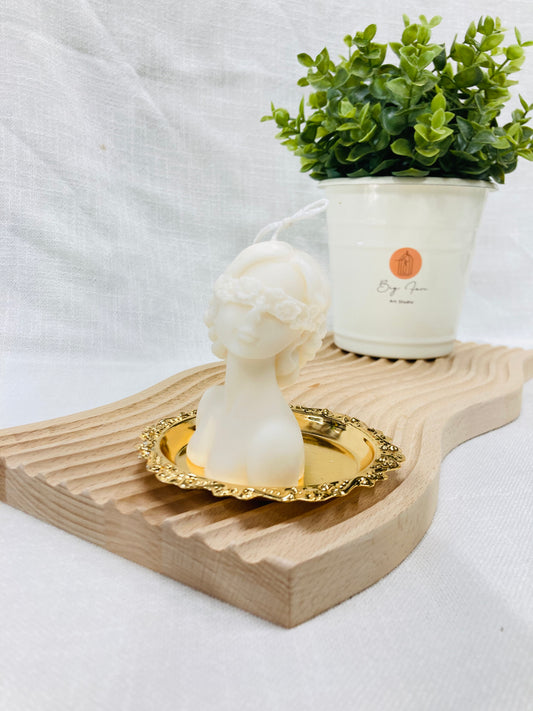 Blindfolded goddess candle close-up showing intricate feminine sculpture and artistic design