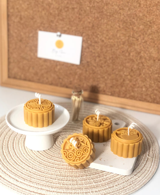 Mooncake candle close-up showing authentic design details, handcrafted soy wax Lunar New Year gift