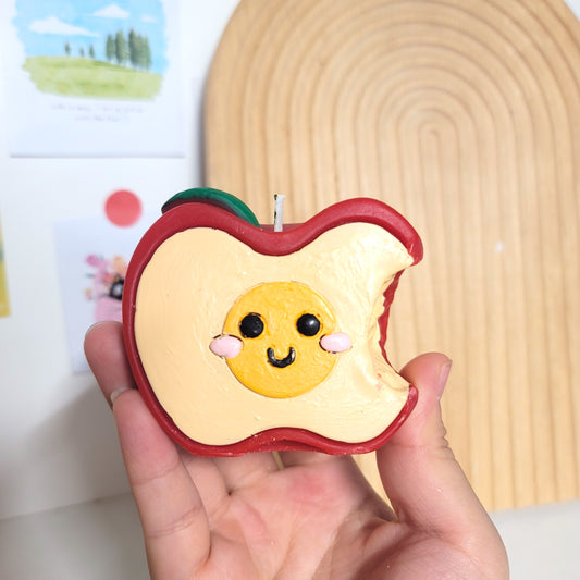 Apple buddy candle with adorable smiling design, cute character sculptural soy wax decor