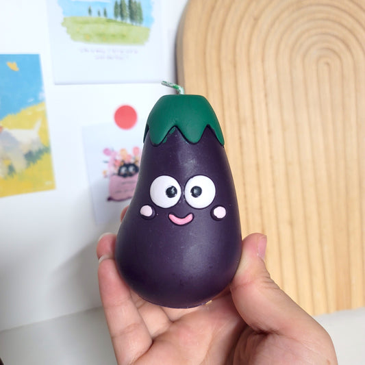 Eggplant buddy candle close-up showing sweet face and charming kawaii appearance